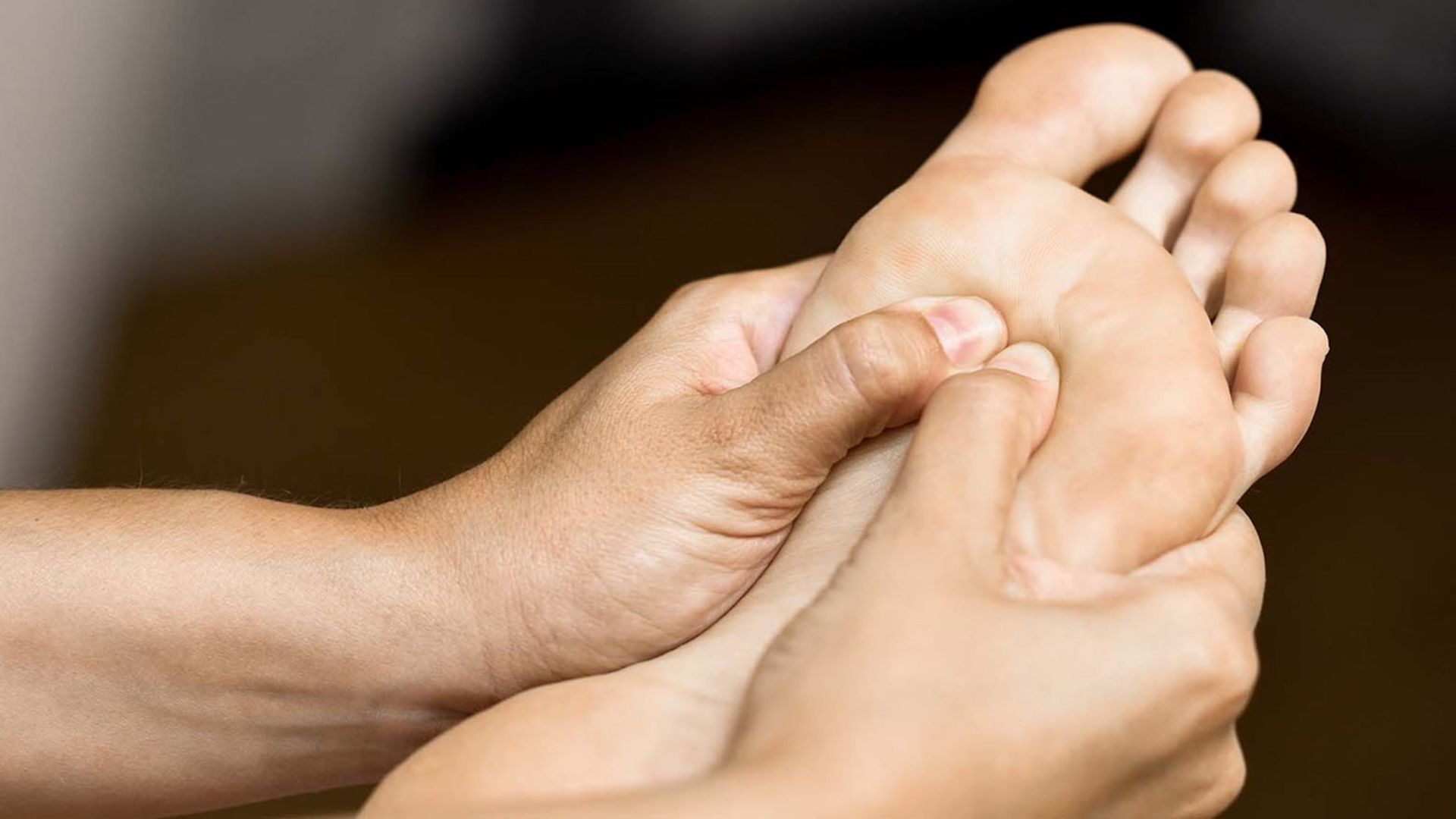 A close up of a foot in a reflexology treatment