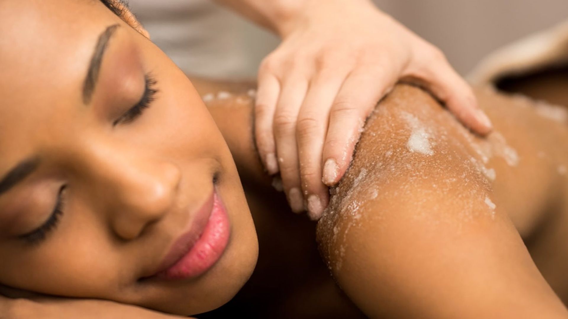 A close up of a woman getting a body treatment at a spa