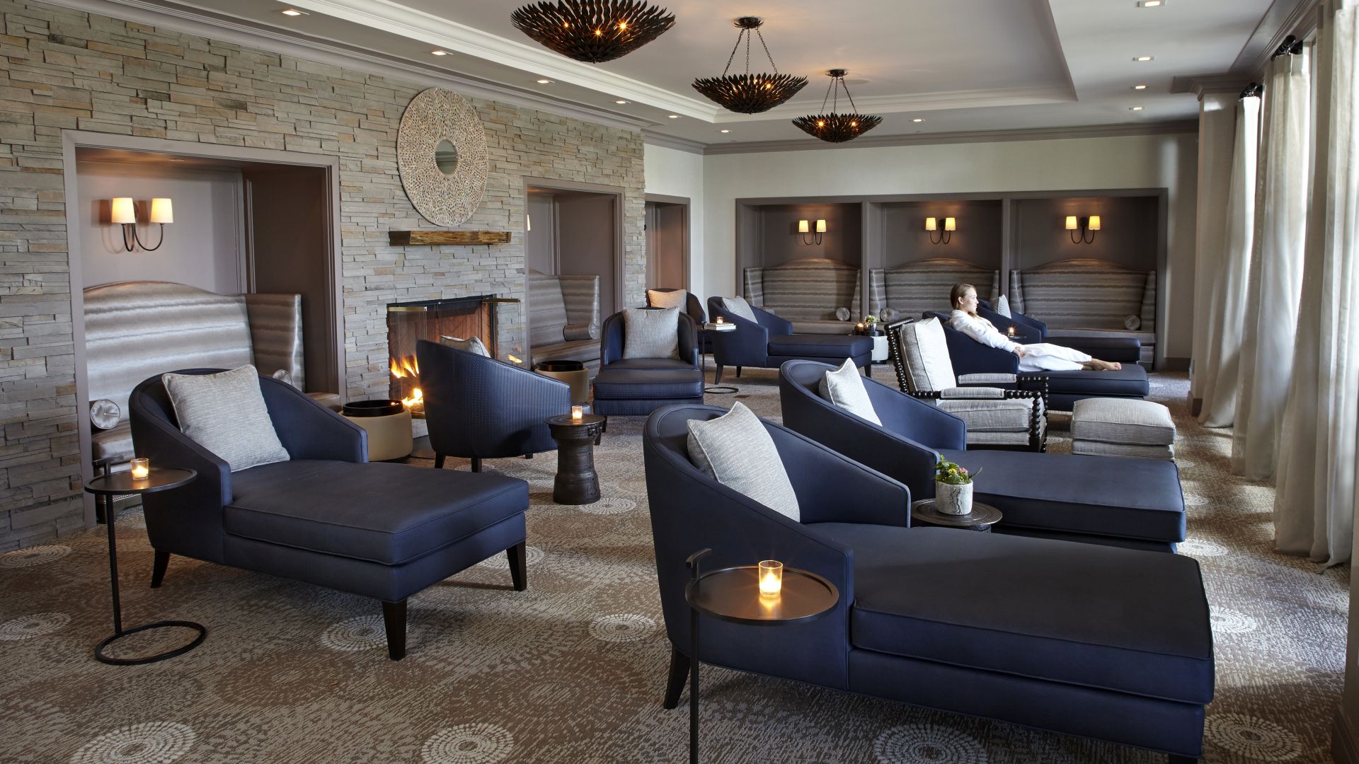 Chaise Lounges looking out floor to ceiling windows in the Whisper Lounge at The Lodge at Woodloch