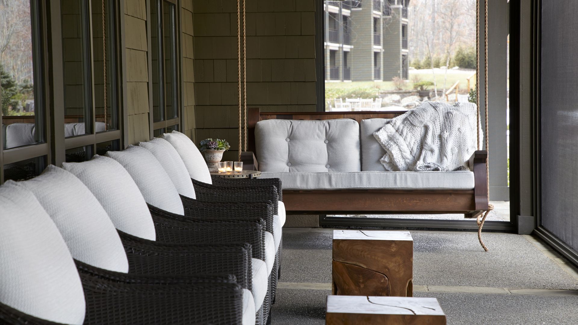 Chairs and a Bench Swing on the Porch of the Whisper Lounge at The Lodge at Woodloch