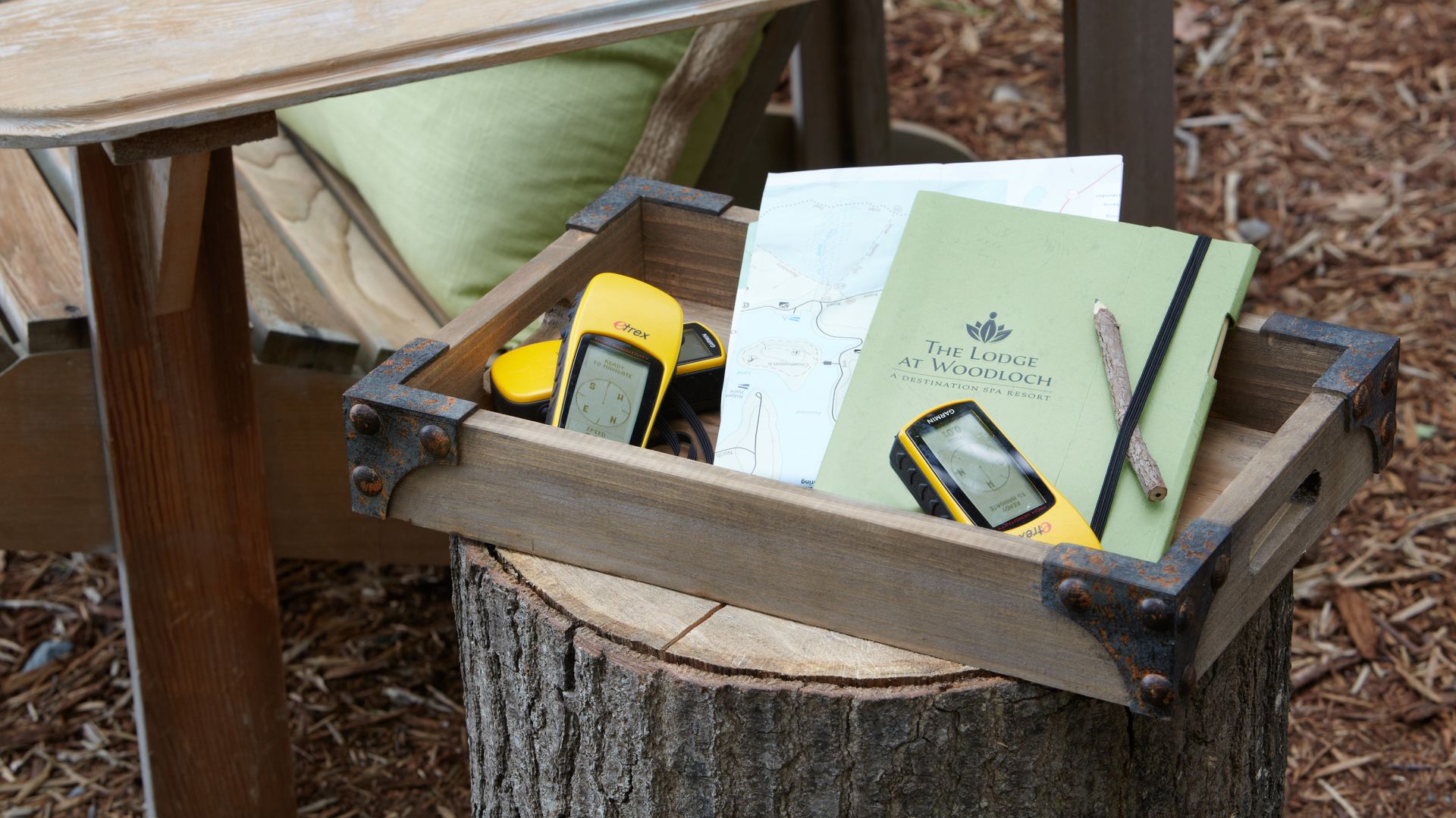 Geocaching equipment sitting next to a Adirondack chair at The Lodge at Woodloch