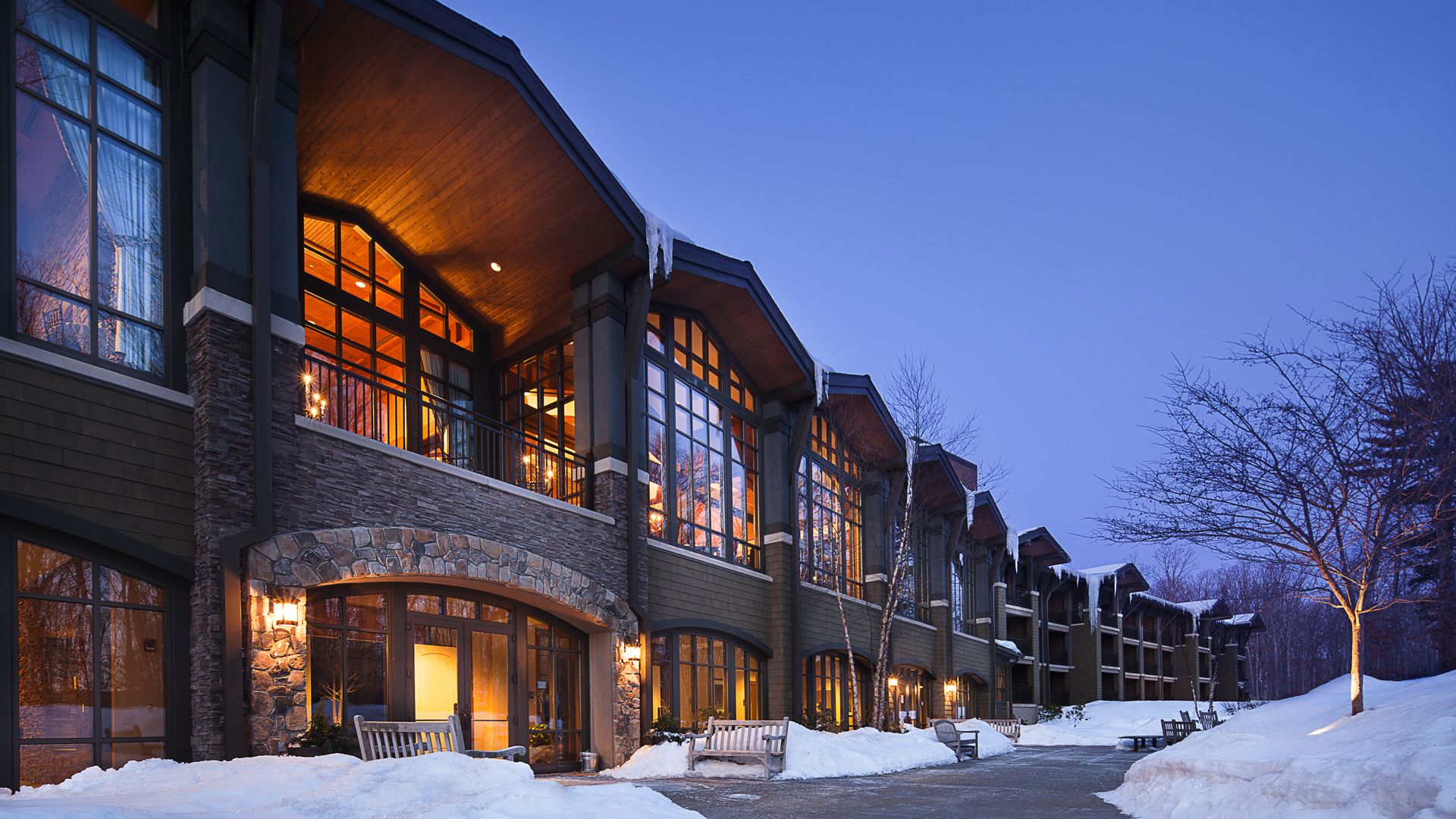 Back exterior view of The Lodge at Woodloch at dusk in Winter