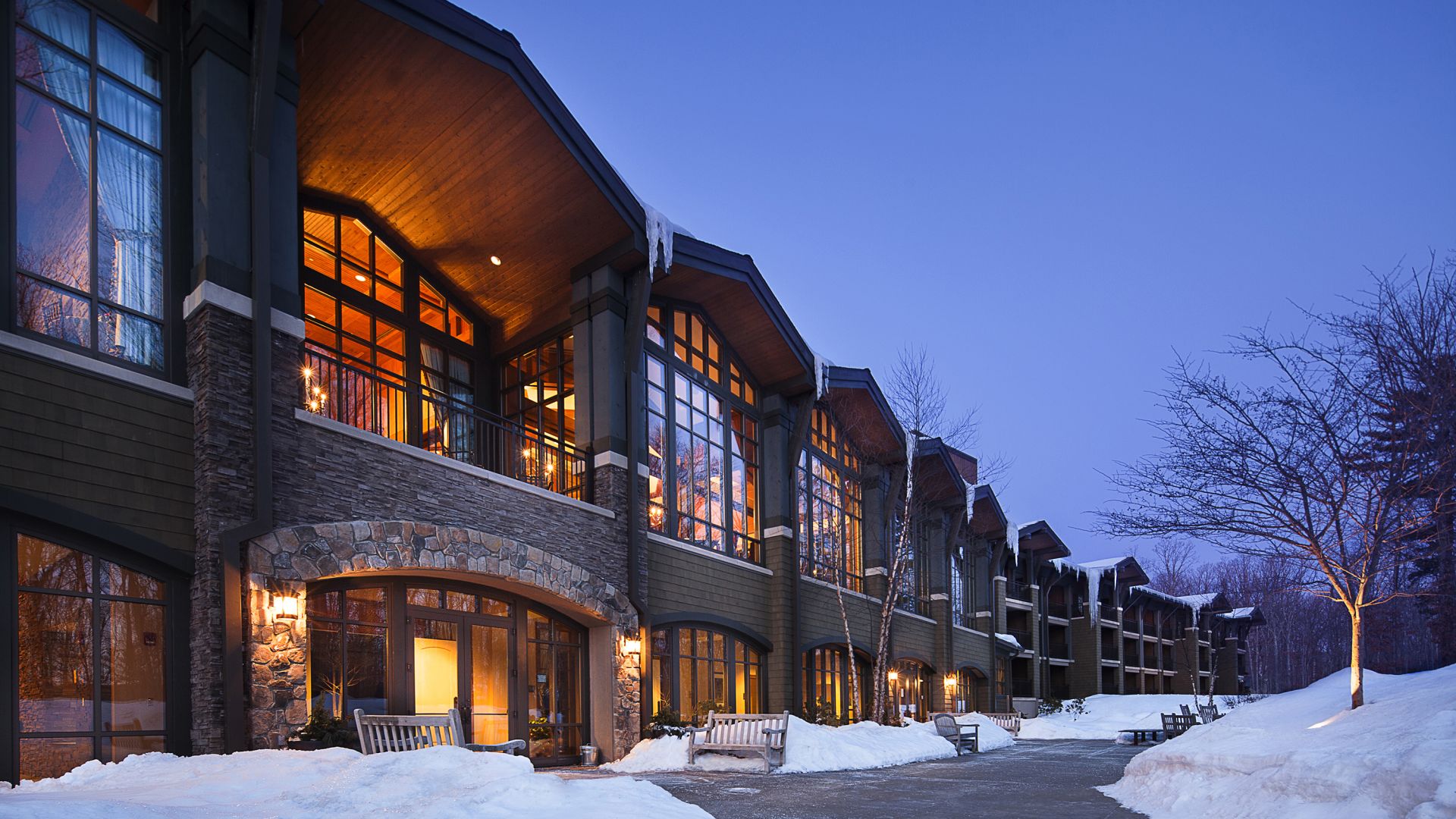 Back exterior view of The Lodge at Woodloch at dusk in Winter