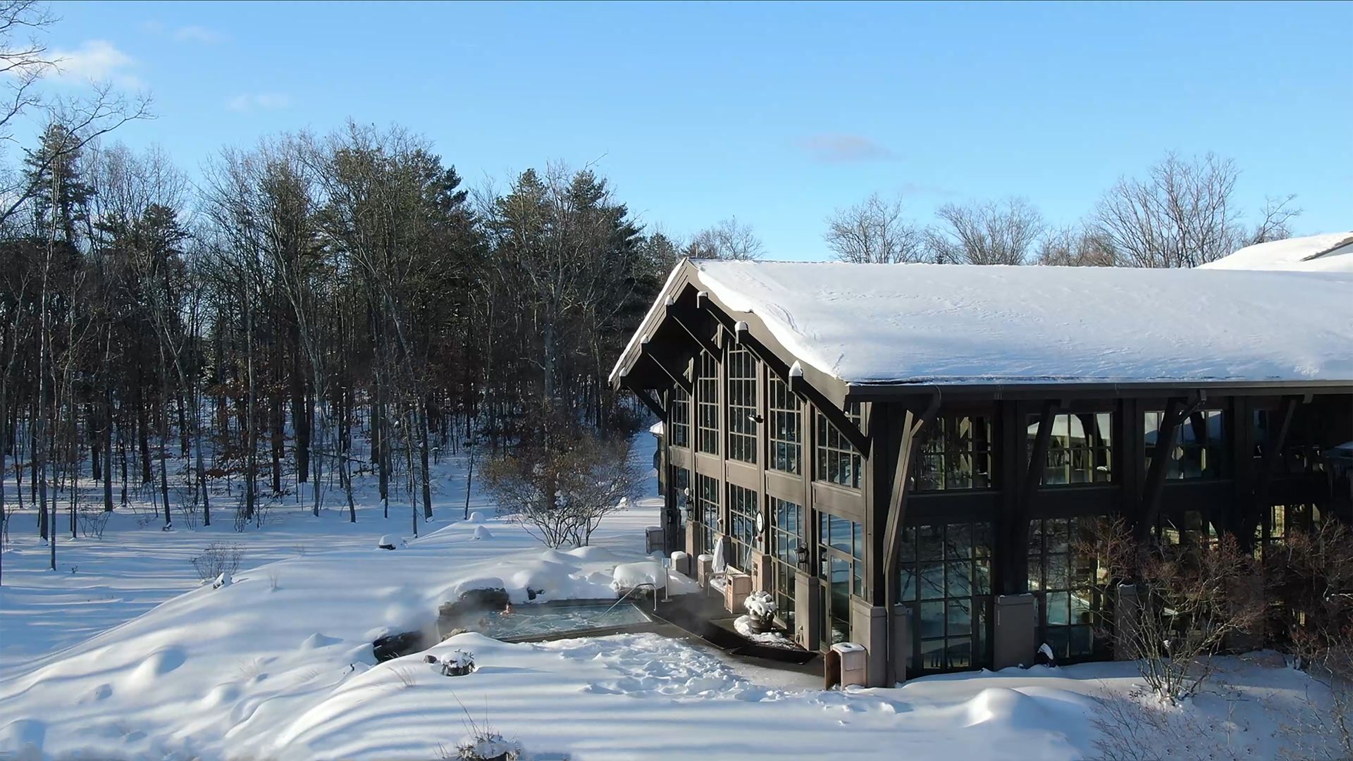 The Lodge at Woodloch and an outdoor horizon edge whilrpool on a sunny day after a fresh snowstorm