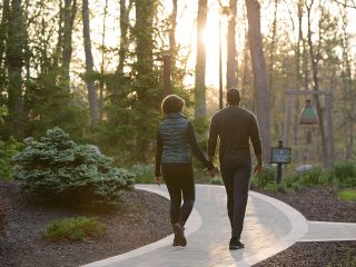 A man and woman embarking on a morning walk at The Lodge at Woodloch